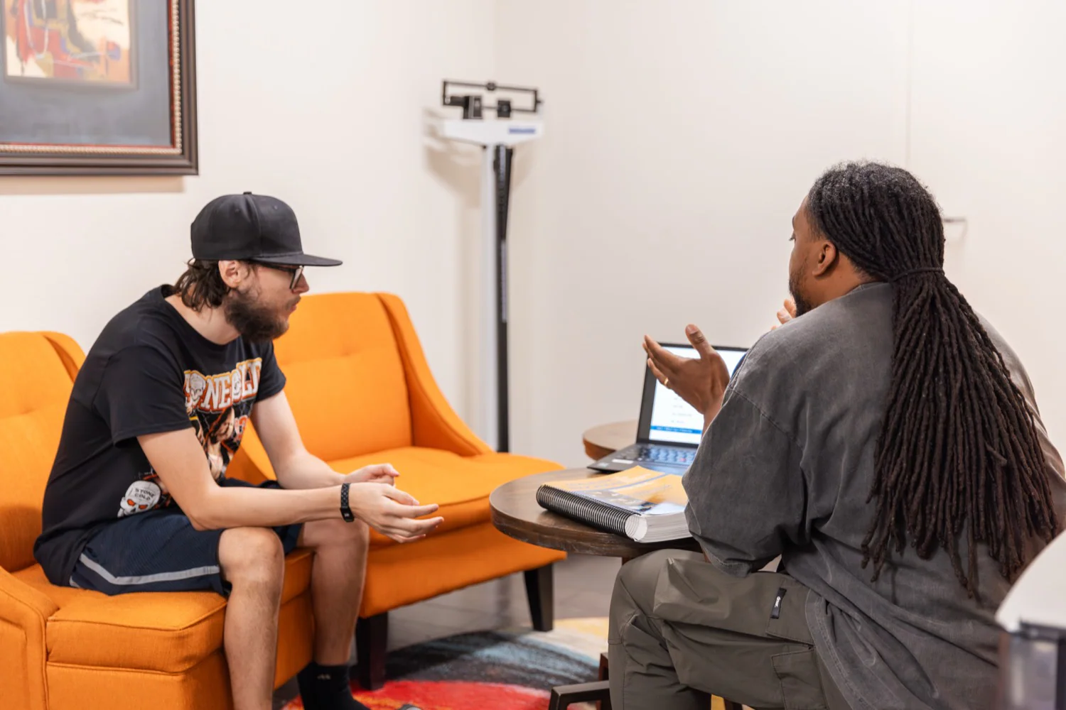 A life coach talking with a resident on the couch