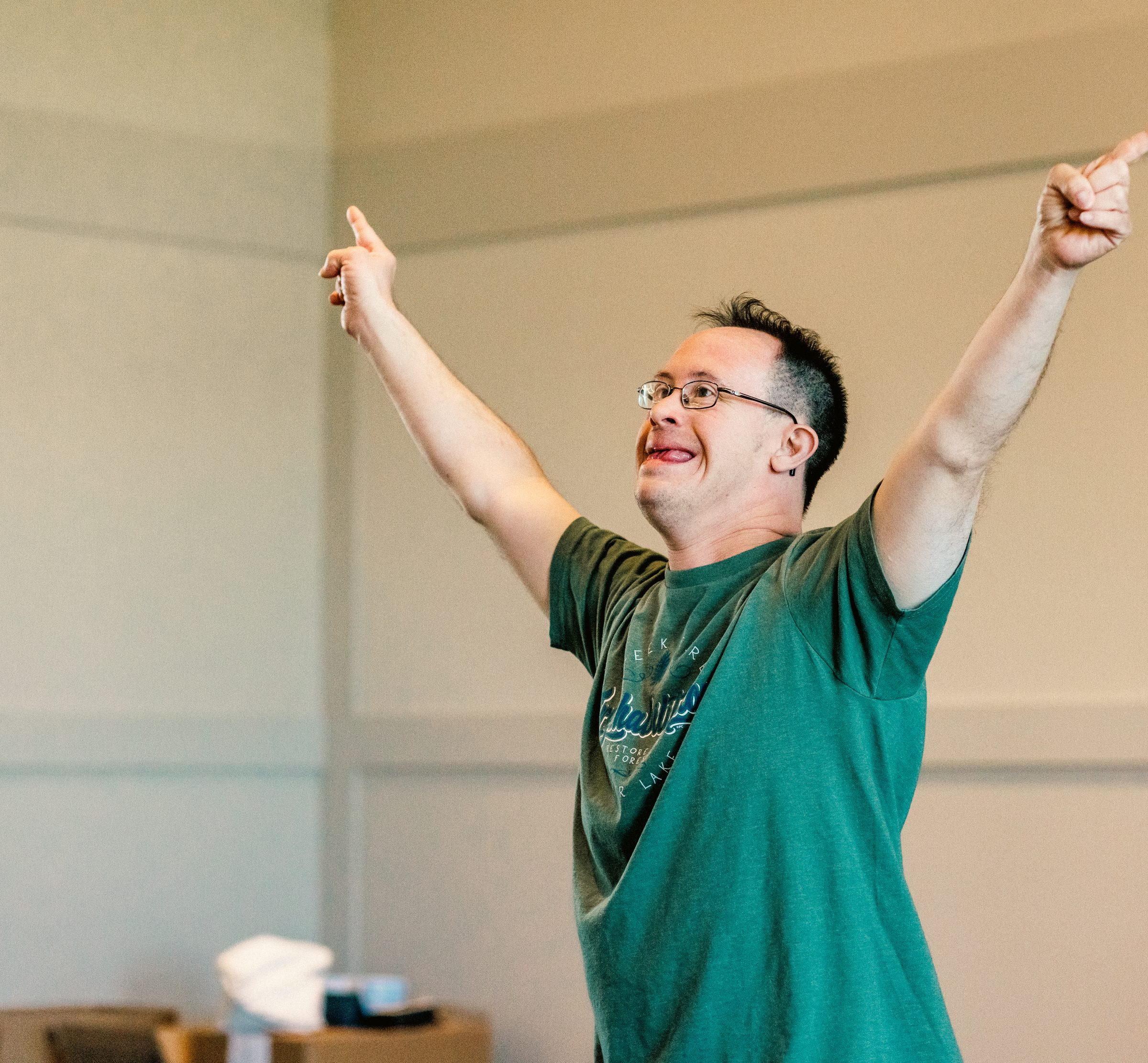 A resident celebrating with both arms raised