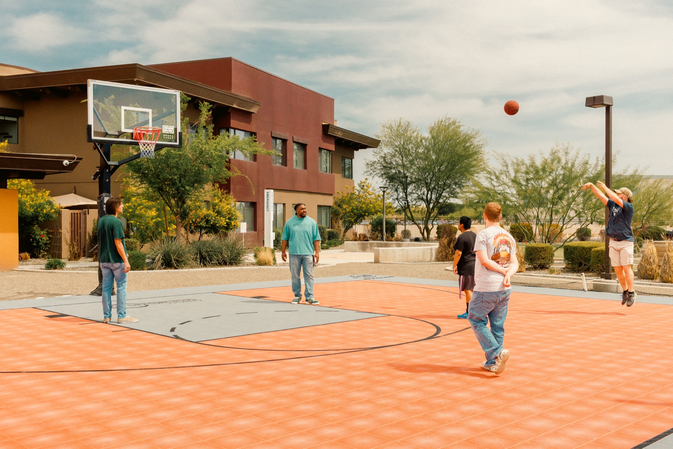 Treasure House residents playing basketball together on the campus court