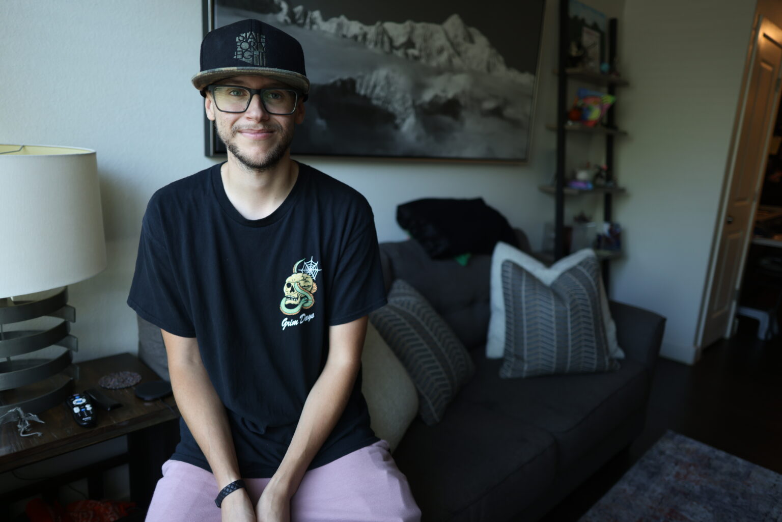 A resident relaxing at home in his Treasure House apartment